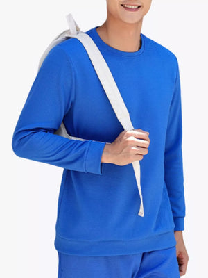 Blue crew neck long sleeve sweatshirt with textured fabric.