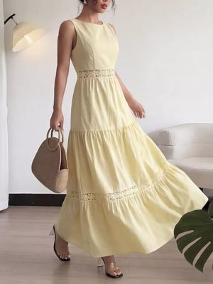 Yellow lace-trimmed maxi dress with boat neckline and tiered skirt.