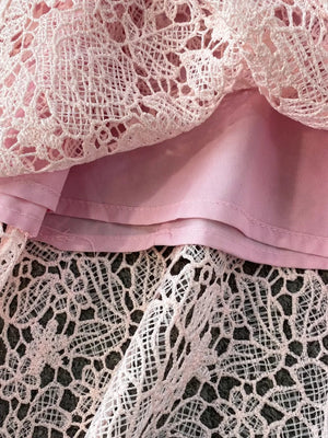 Blush pink lace peplum detail on an elegant two-piece ensemble.