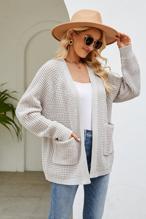 Light gray waffle knit raglan pocket cardigan with open front and long sleeves.