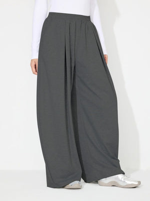 Dark gray pleated drape palazzo trousers with a wide leg and elastic waistband.