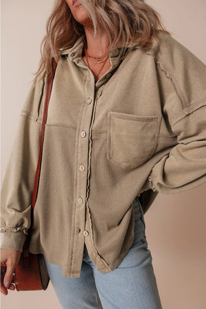 Tan waffle knit overshirt with patch pocket and button front, styled casually.