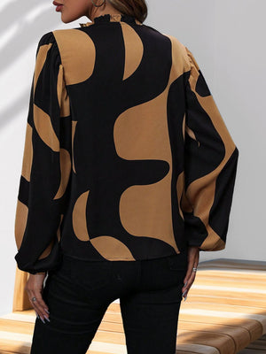 Black and tan geometric print blouse with voluminous sleeves and ruffled neckline.