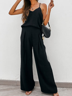 Black cami and pleated palazzo pants set with a V-neck camisole and wide-leg trousers.