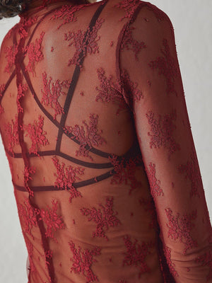 Deep red floral lace illusion mock neck blouse with sheer long sleeves.