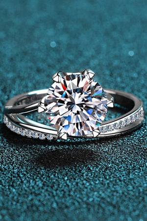 Silver bypass ring with large solitaire diamond and pavé band.