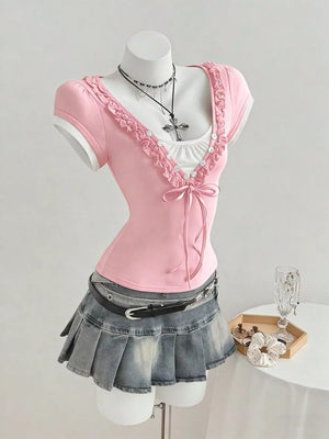 Pink maternity t-shirt with frill trim, bow detail, and white layered neckline.