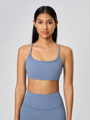 Strappy back active crop top in Dusty Blue with a scoop neckline.