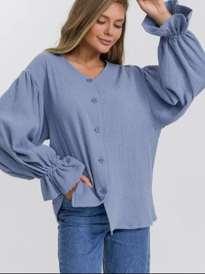 Light blue textured puff sleeve blouse with ruffled cuffs and button front