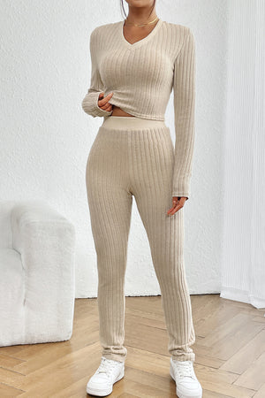 Beige ribbed knit co-ord set with V-neck crop top and fitted pants.