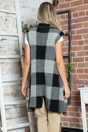 Geometric knit duster vest in black and tan with a checkered pattern and shawl collar.