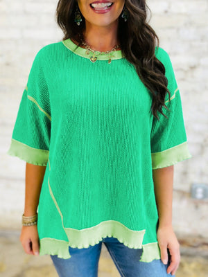 Bright green ribbed t-shirt with contrast trim and asymmetrical hem
