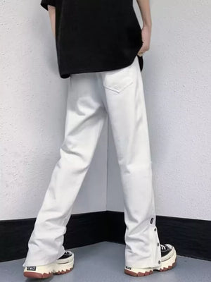 White distressed loose-fit jeans with snap detail at the hem