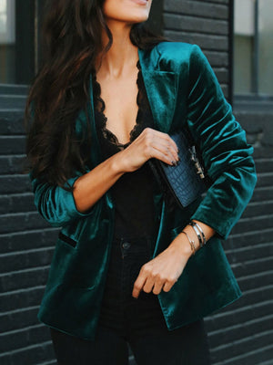Emerald velvet blazer with black lapels and button front, styled with black lace top.