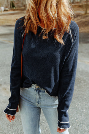 Navy waffle knit raglan sweater with ruffled cuffs and contrast stitching