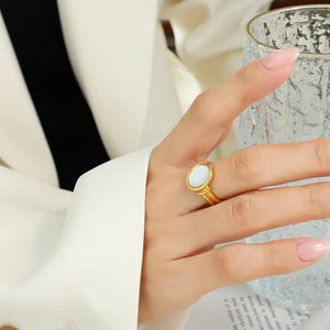 Gold mother-of-pearl oval signet ring with a polished finish.