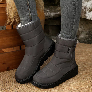 Gray quilted round toe platform boots with adjustable strap and chunky sole.