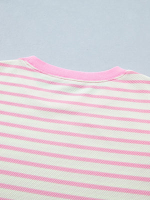 Ruffled short-sleeve blouse in white and pink stripes with a pink neckline.