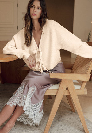 Ivory bouclé knit cardigan with tie-front detail.
