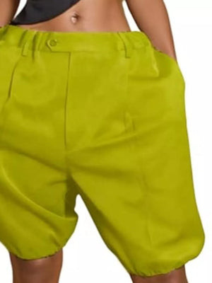 Yellow green pleated high-waisted shorts with drawstring and pockets.