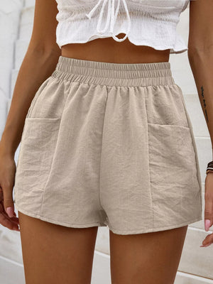 Beige linen blend shorts with elastic waist and two front pockets.