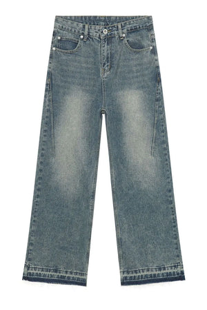 Distressed wide-leg denim jeans in medium wash with a raw hem.