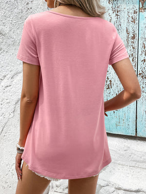 Pink t-shirt with short sleeves and a scoop neck, featuring a floral lace yoke detail.