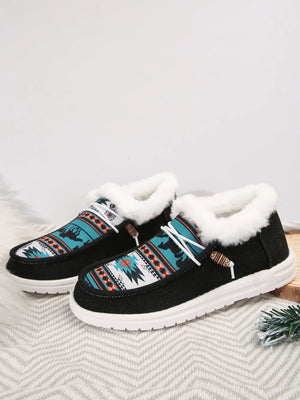 Southwestern print faux fur lined loafers in black with white laces and wooden toggles.