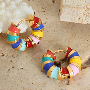 Rainbow enamel segmented hoop earrings in gold with colorful segments.
