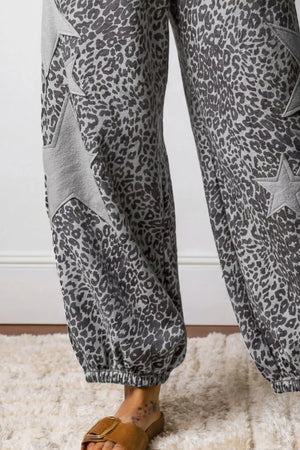 Leopard print wide-leg pants with grey star accents and elastic cuffs.