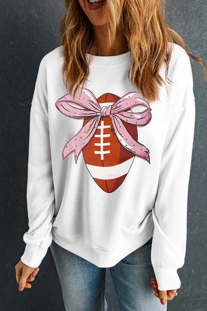 White crewneck sweatshirt with a football graphic adorned with a pink polka dot bow.