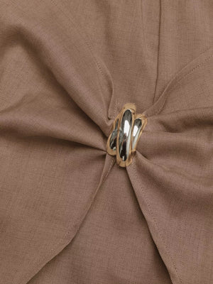Brown twist-front skort with a decorative silver button detail.