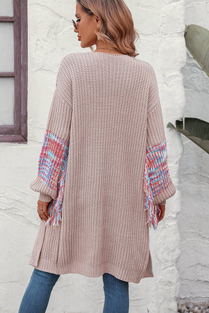 Textured sleeve fringe cardigan in acrylic with colorful woven detail and fringe.
