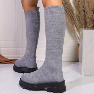 Gray knit knee-high boots with chunky platform soles and pull tabs.
