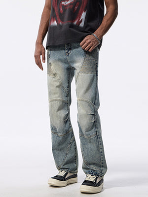 Men's light wash wide-leg jeans with moto-inspired paneling and whiskering detail.