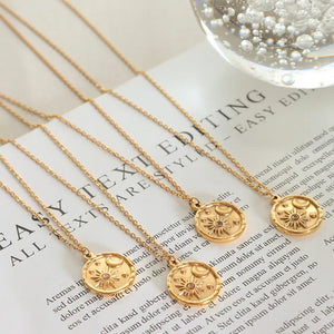 Gold zirconia coin necklace with sun and moon design