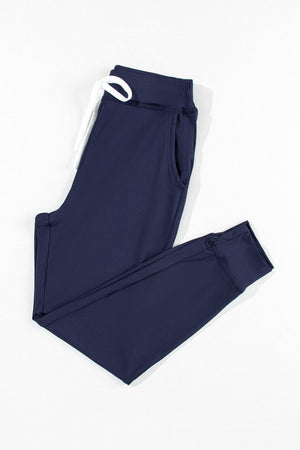 Slim-fit navy joggers with white drawstring and side pockets.