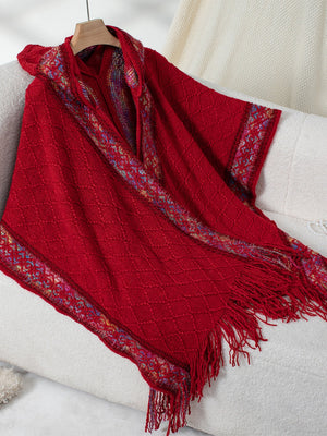 Red knit hooded wrap coat with embroidered trim and fringe detail.