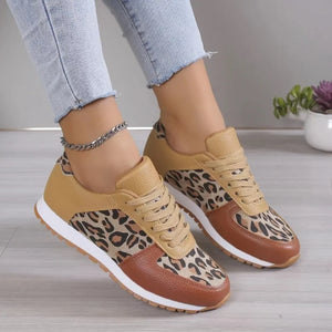 Leopard print panel runner sneakers in tan and brown with white soles.