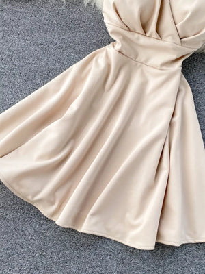 Apricot V-neck spaghetti strap mini dress with a draped bodice and flared skirt.