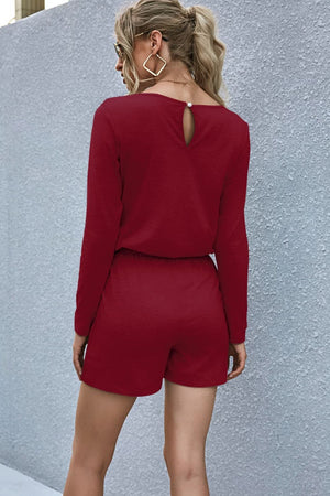 Essential Jersey Pocket Romper in Wine with long sleeves and a keyhole back detail.