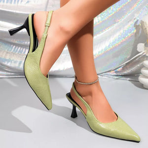 Elegant green kitten heel slingback pumps with embossed pattern and black heel.