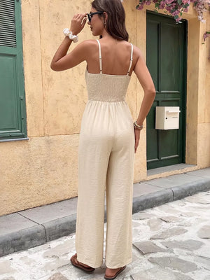 Lace-trimmed spaghetti strap romper in cream with smocked bodice and wide legs.