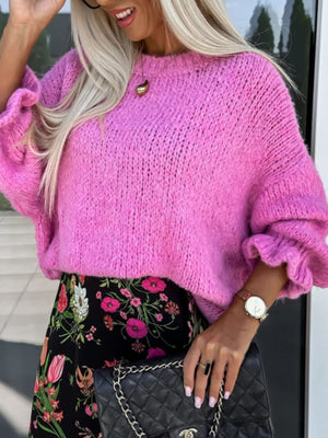 Fuchsia pink knit sweater with voluminous ruffled sleeves and crewneck.