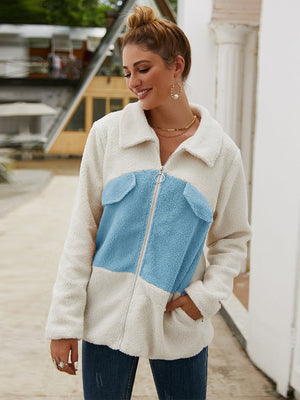 Colorblock shearling zip-up jacket with light blue accents and a zip front.
