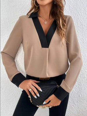 Camel blouse with contrast black collar and cuffs, V-neck, long sleeves.