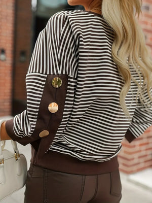 Brown and white striped sweatshirt with decorative gold buttons on the sleeves.