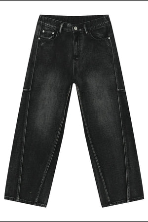 Dark wash denim trousers with exaggerated seam details and a wide leg