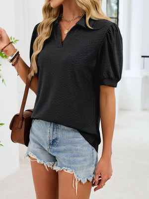 Black eyelet collar top with puff sleeves and a v-neckline.