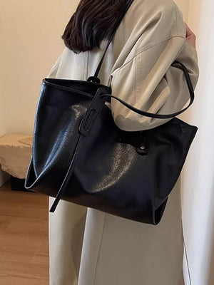 Black pu leather shoulder bag with slouchy design and top handle detail